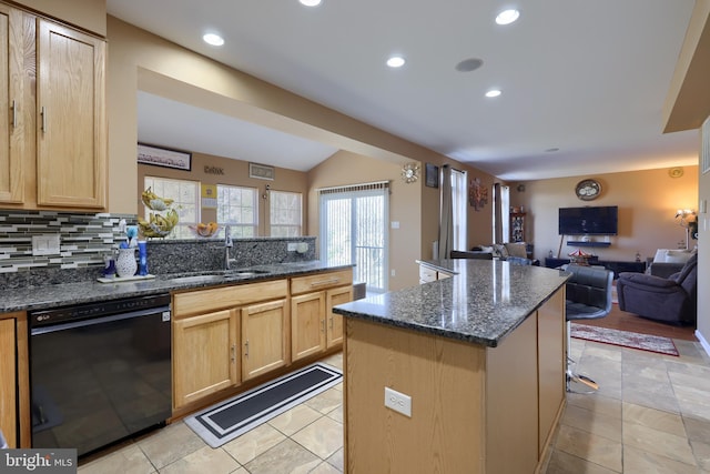 kitchen with dark stone countertops, decorative backsplash, dishwasher, and sink