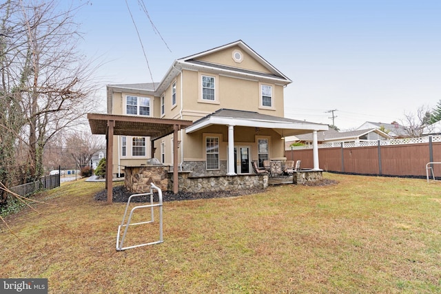 rear view of house featuring a pergola and a yard