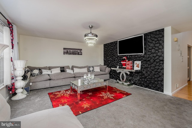 living room featuring a chandelier and carpet flooring