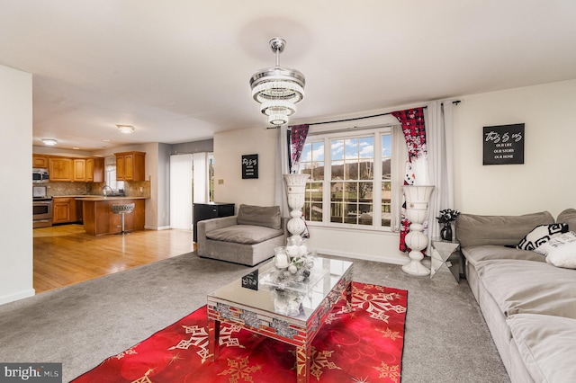 living room featuring light hardwood / wood-style floors and a chandelier