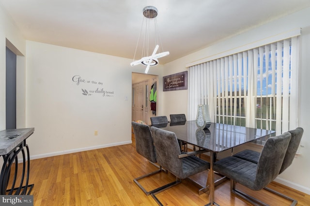 dining area featuring a chandelier and light wood-type flooring