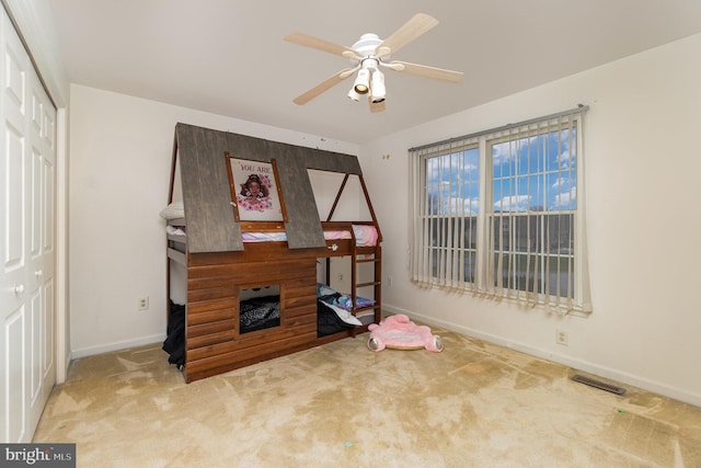 interior space with ceiling fan and light carpet