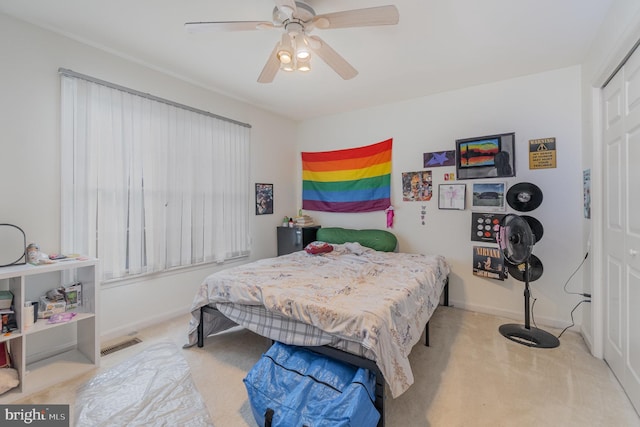 carpeted bedroom with a closet and ceiling fan