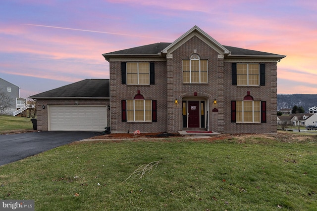 view of front of home featuring a garage and a yard