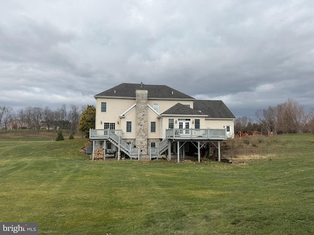 back of house with a lawn and a wooden deck