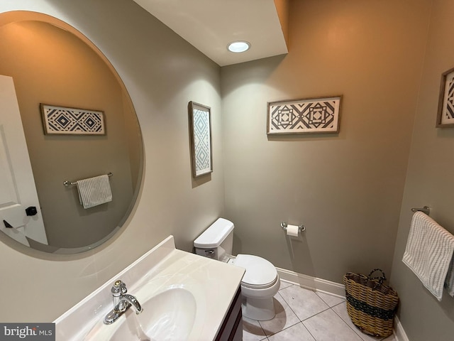 bathroom with tile patterned flooring, vanity, and toilet