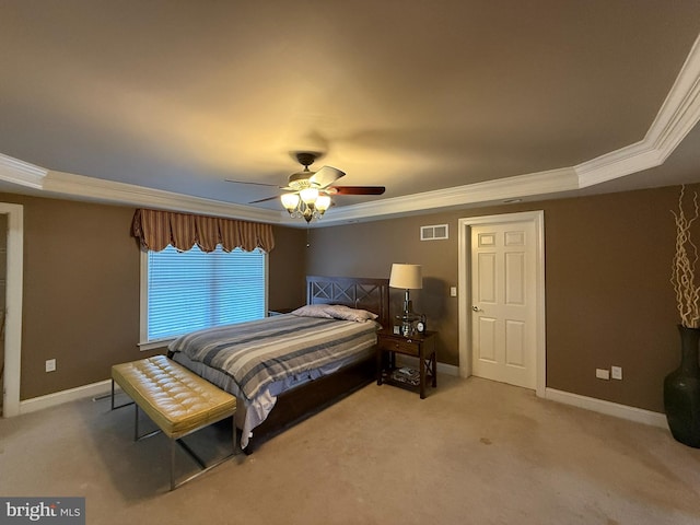 bedroom featuring carpet flooring, ceiling fan, a raised ceiling, and ornamental molding