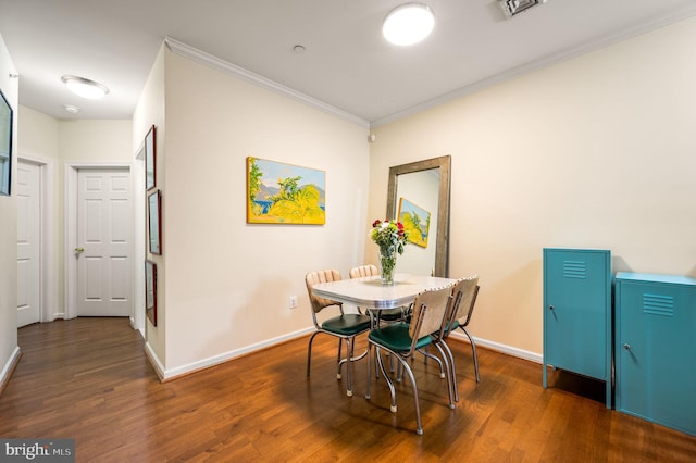 dining space featuring dark hardwood / wood-style flooring and ornamental molding