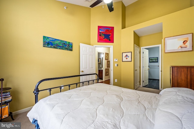 bedroom featuring carpet, ensuite bathroom, and ceiling fan