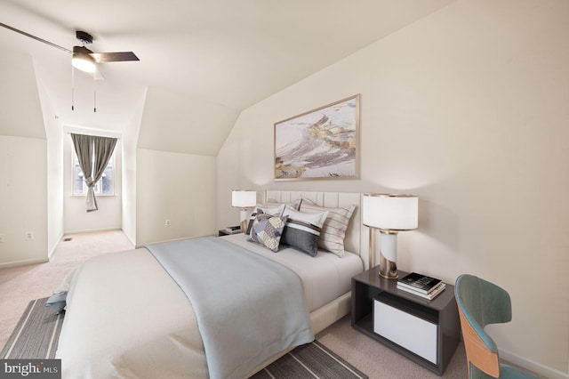 carpeted bedroom with ceiling fan and vaulted ceiling