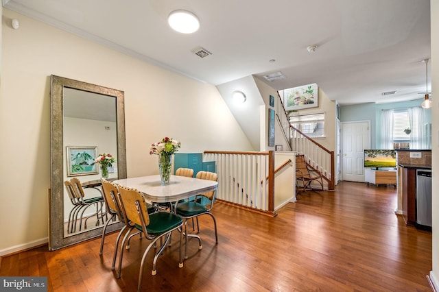 dining area with ceiling fan, dark hardwood / wood-style flooring, and crown molding