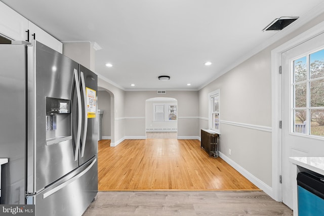 kitchen with white cabinets, stainless steel fridge with ice dispenser, light hardwood / wood-style flooring, and plenty of natural light