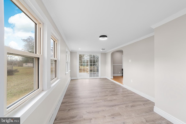 spare room with light hardwood / wood-style flooring and ornamental molding