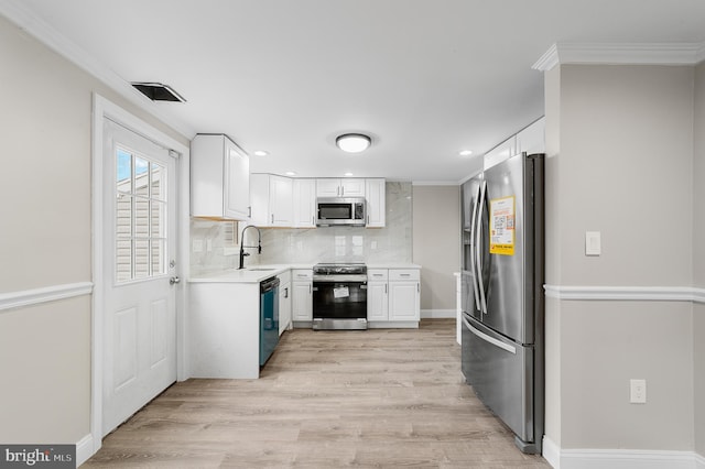 kitchen featuring white cabinets, light hardwood / wood-style floors, and stainless steel appliances