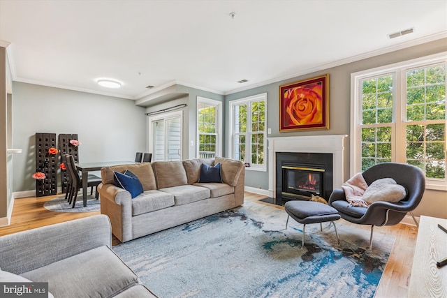 living room featuring light hardwood / wood-style flooring and ornamental molding