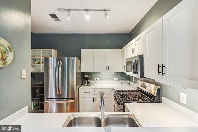 kitchen with sink, white cabinetry, and stainless steel appliances