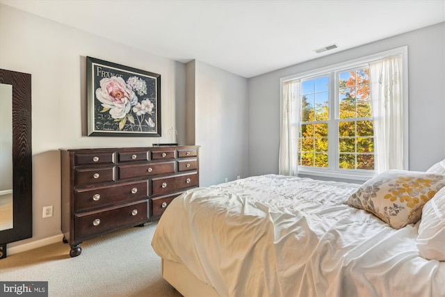 bedroom featuring light carpet