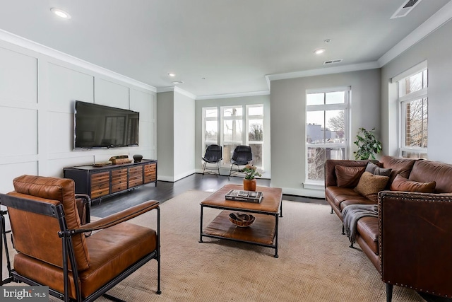 living room with wood-type flooring and ornamental molding