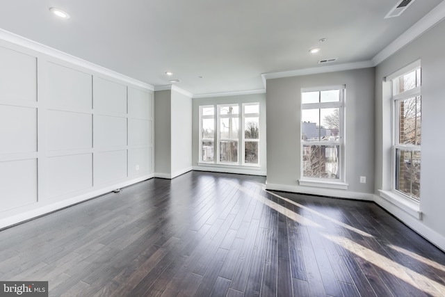 spare room featuring crown molding and dark wood-type flooring