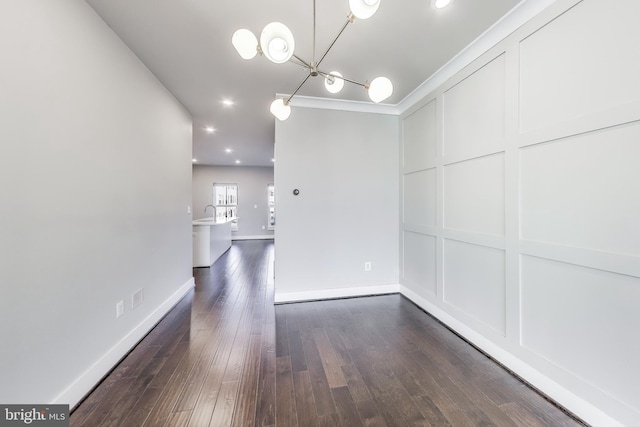 unfurnished dining area with crown molding and dark wood-type flooring