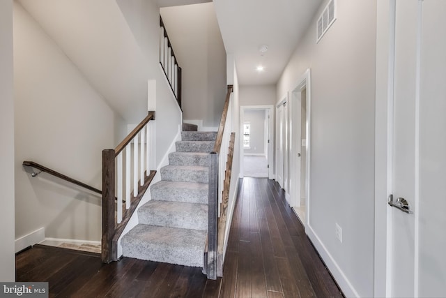 stairs featuring hardwood / wood-style flooring