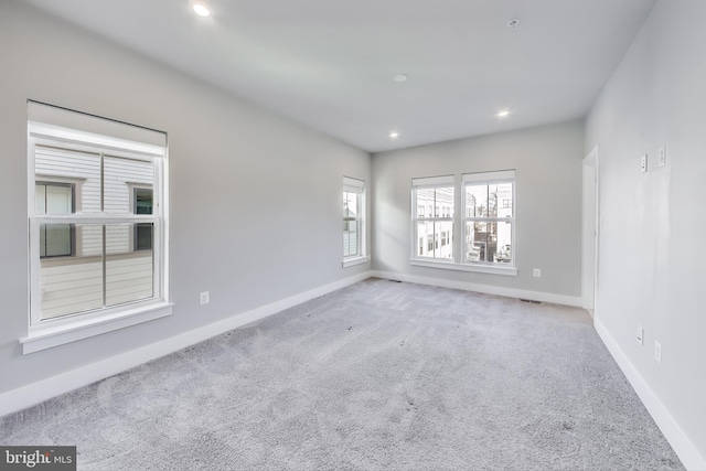 empty room with light colored carpet