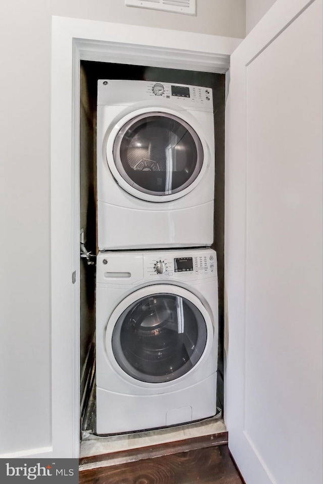 laundry area featuring stacked washing maching and dryer