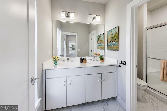 bathroom featuring vanity, toilet, and walk in shower