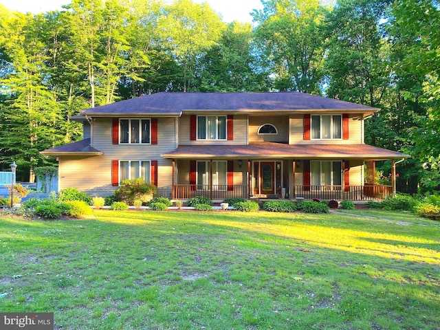 view of front of home featuring covered porch and a front yard