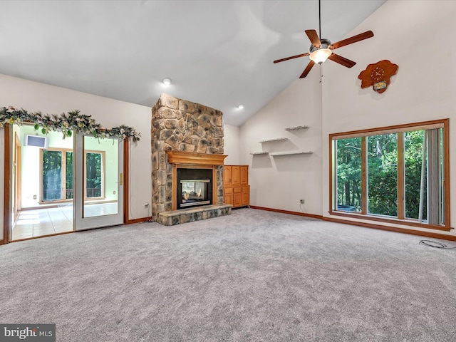 unfurnished living room featuring ceiling fan, a fireplace, high vaulted ceiling, and a healthy amount of sunlight