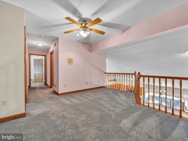 unfurnished room featuring ceiling fan and carpet