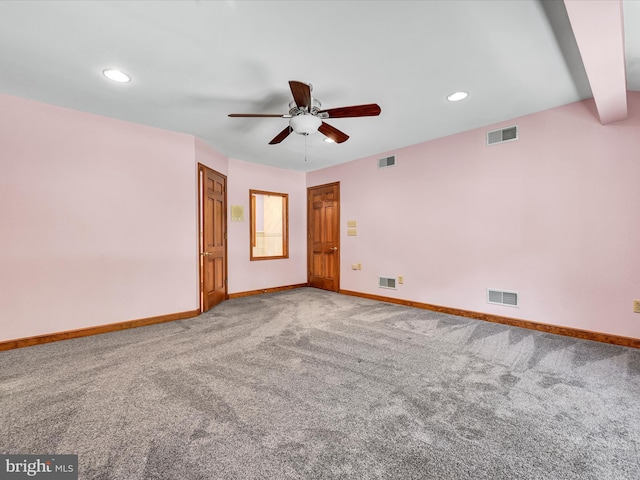 carpeted spare room with beamed ceiling and ceiling fan