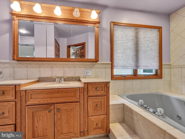 bathroom with vanity and tiled bath