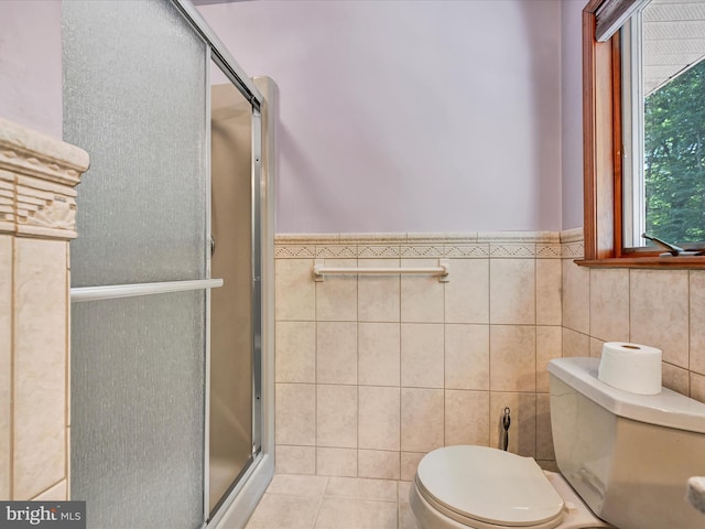 bathroom with tile patterned floors, tile walls, an enclosed shower, and toilet