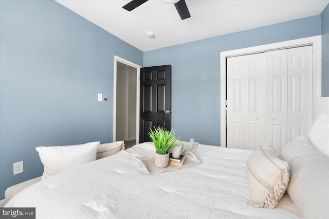 bedroom featuring ceiling fan and a closet