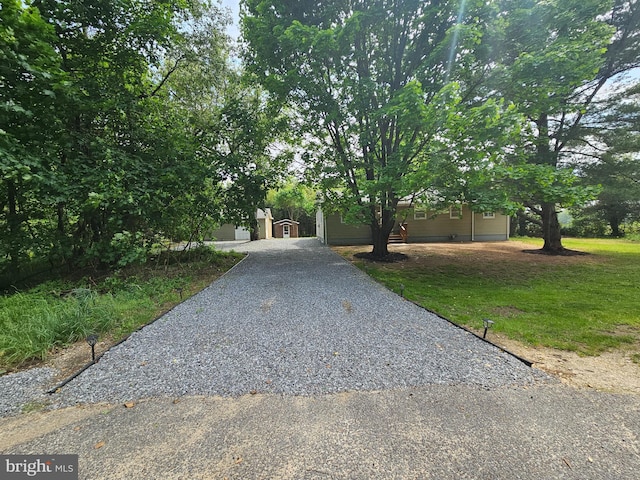 obstructed view of property featuring a front yard