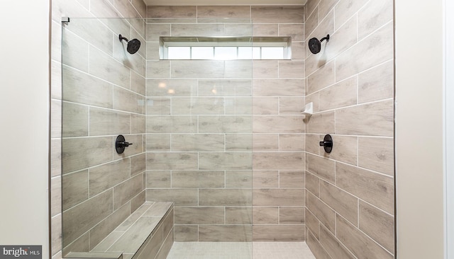 bathroom with tiled shower