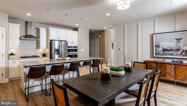 dining space featuring light hardwood / wood-style floors