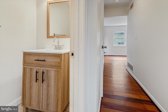 bathroom featuring vanity and hardwood / wood-style flooring