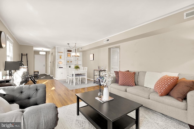 living room featuring hardwood / wood-style floors and a chandelier