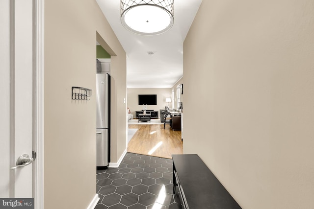 hall featuring dark tile patterned flooring