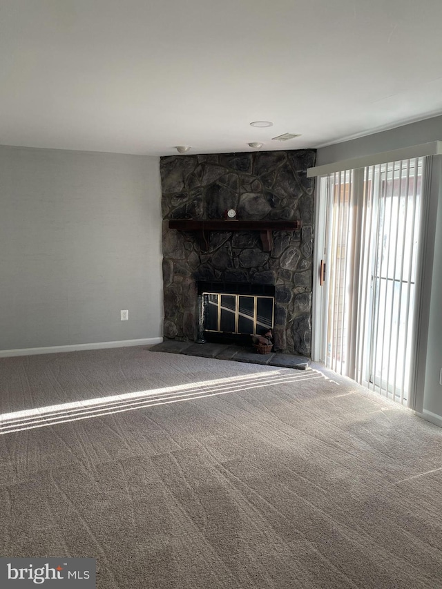 unfurnished living room featuring carpet flooring and a fireplace