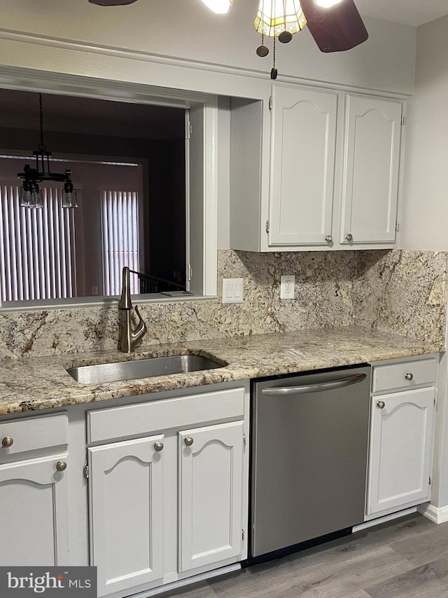 kitchen featuring backsplash, sink, stainless steel dishwasher, light hardwood / wood-style floors, and white cabinetry