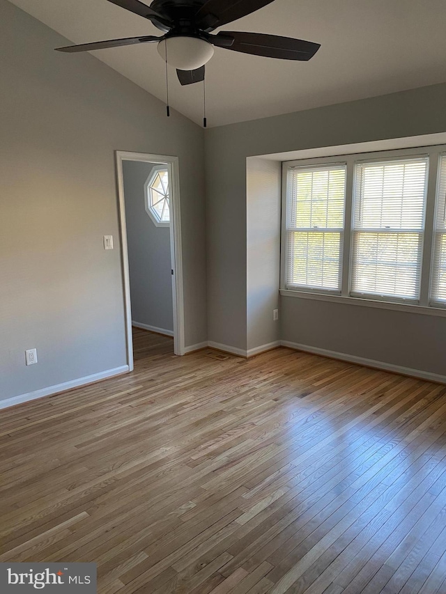 foyer with ceiling fan, lofted ceiling, and light wood-type flooring