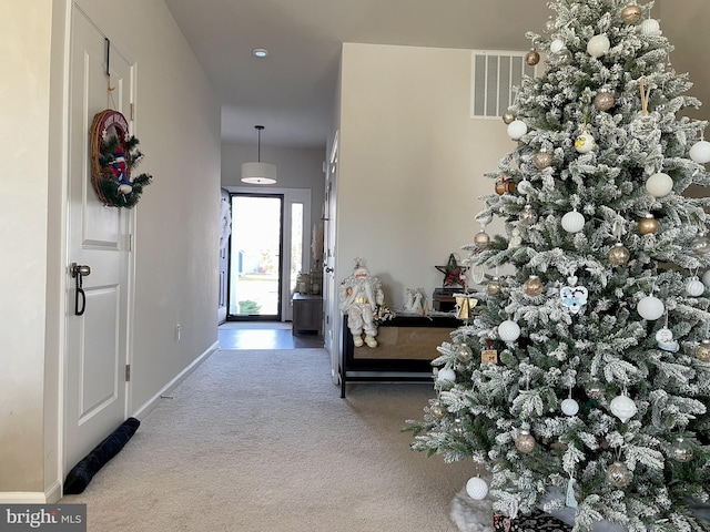 view of carpeted foyer entrance