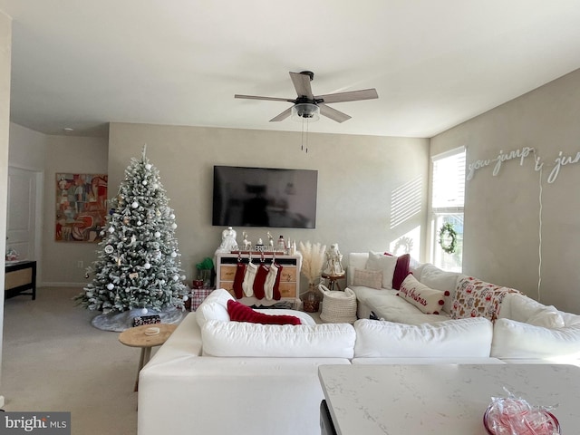 carpeted living room featuring ceiling fan