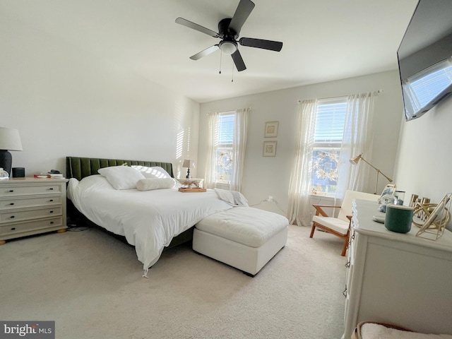 bedroom featuring ceiling fan and light carpet