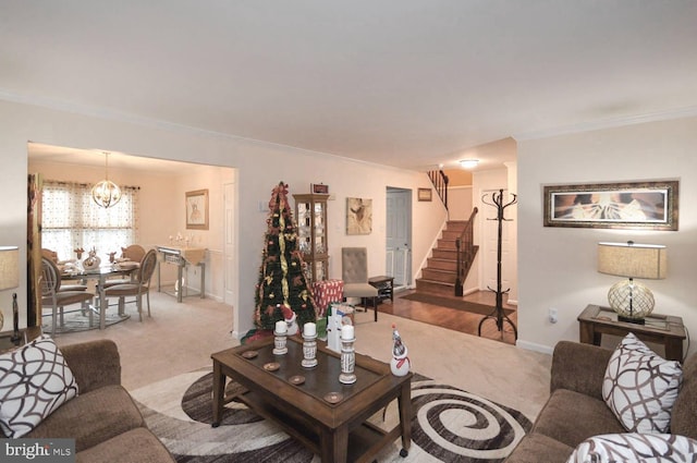 living room featuring carpet, crown molding, and a chandelier