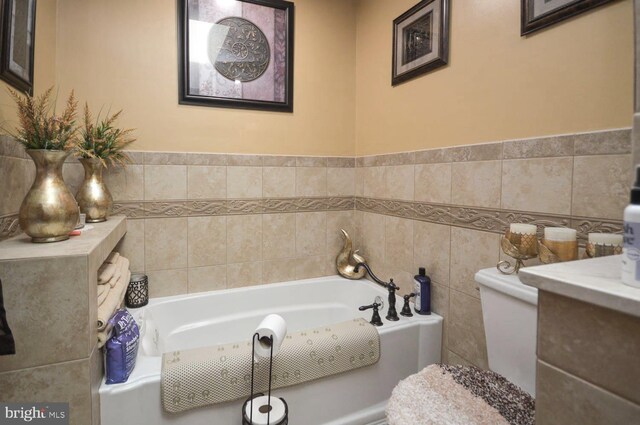 bathroom with a tub to relax in and tile walls