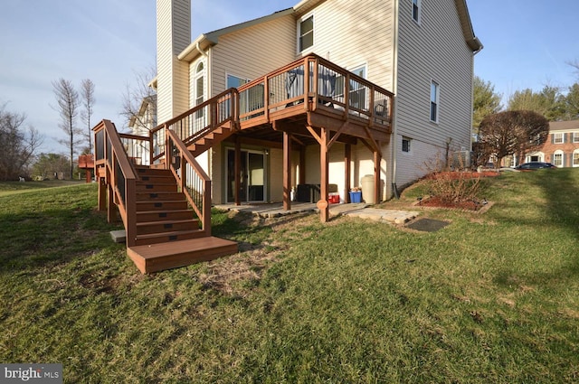 back of property featuring a deck and a lawn